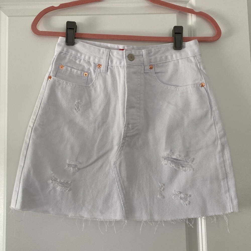 Ladies new with tags  White denim distressed skirt size small.